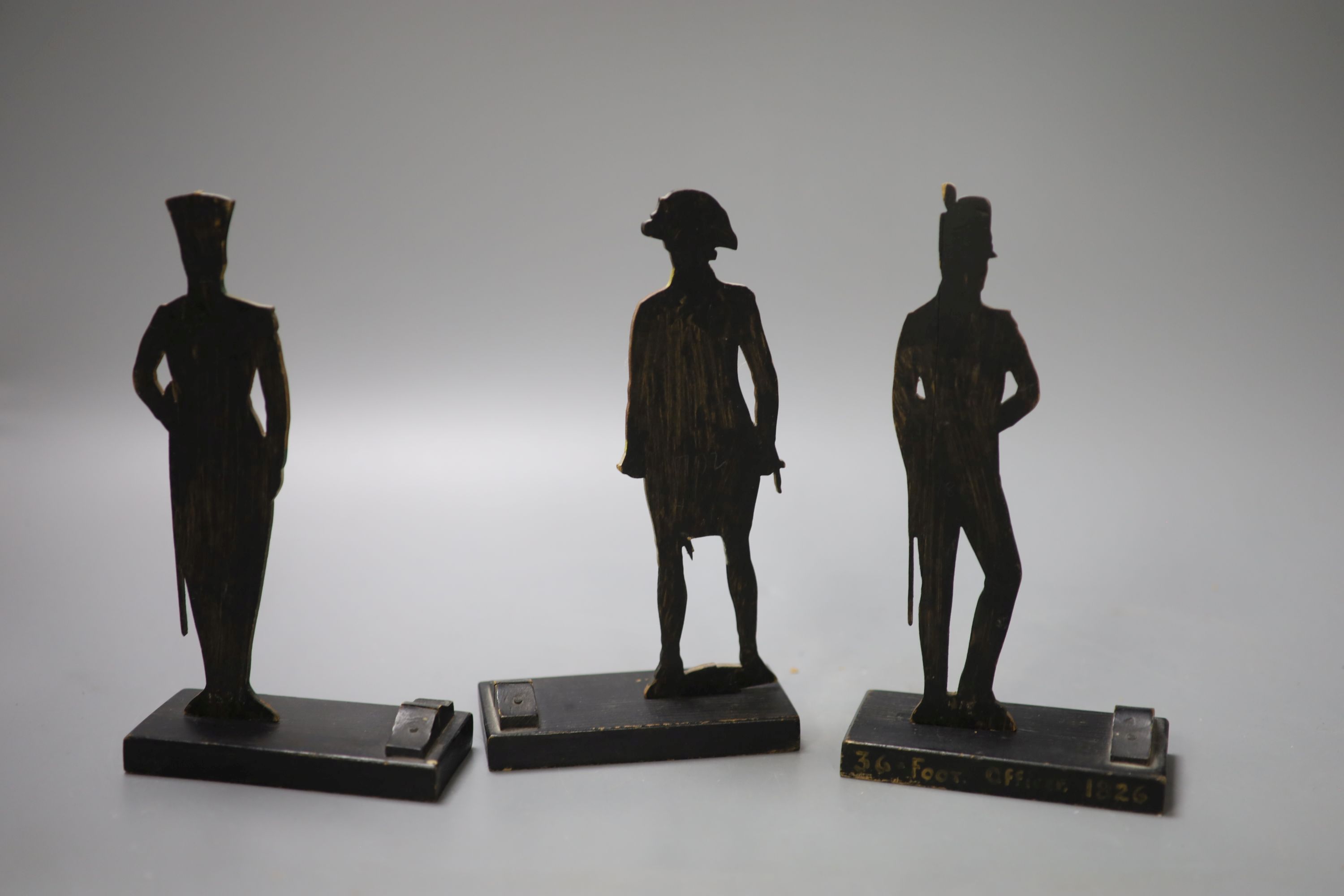 Three fret-cut wooden Military figures, tallest 18cm